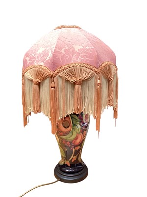 Lot 1131 - Moorcroft pottery table lamp decorated in the Queens Choice pattern