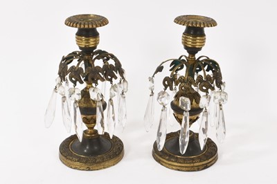 Lot 802 - Pair of 19th century bronze candlesticks with cut glass drops