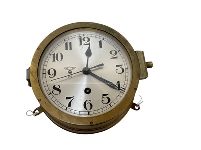 Lot 726 - Second World War Nazi German Kriegsmarine ships bulkhead clock in brass case, with silvered Arabic numeral dial with Eagle Swastika above'.