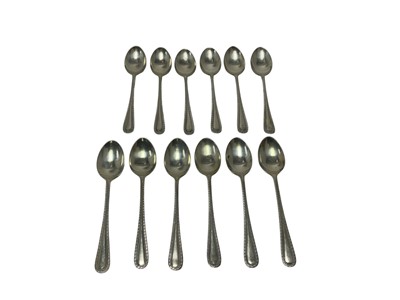 Lot 321 - Two sets of six 1920s silver feather edge teaspoons by Hukin and Heath Ltd