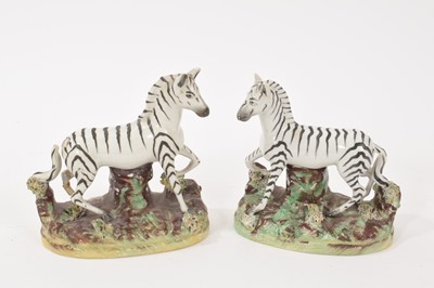 Lot 228 - Pair of Staffordshire pottery models of zebra