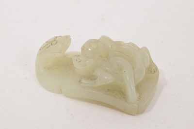 Lot 857 - 19th century Chinese celadon jade belt buckle with qilin ornament