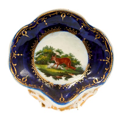 Lot 215 - A Worcester Fable shell shaped dish, circa 1768, painted by Jefferyes Hamett O'Neale with The Fox and the Sheep, within gilt cartouche, gilt dentil rim, 20.75cm wide