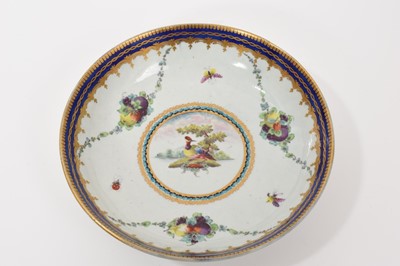 Lot 34 - A Worcester 'Lord Rodney' type saucer dish, circa 1770, painted with a colourful bird, swags of fruit and insects, with gilded blue edges, 16cm diameter
