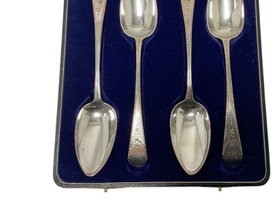 Lot 250 - Cased set of four George III bright cut silver table spoons