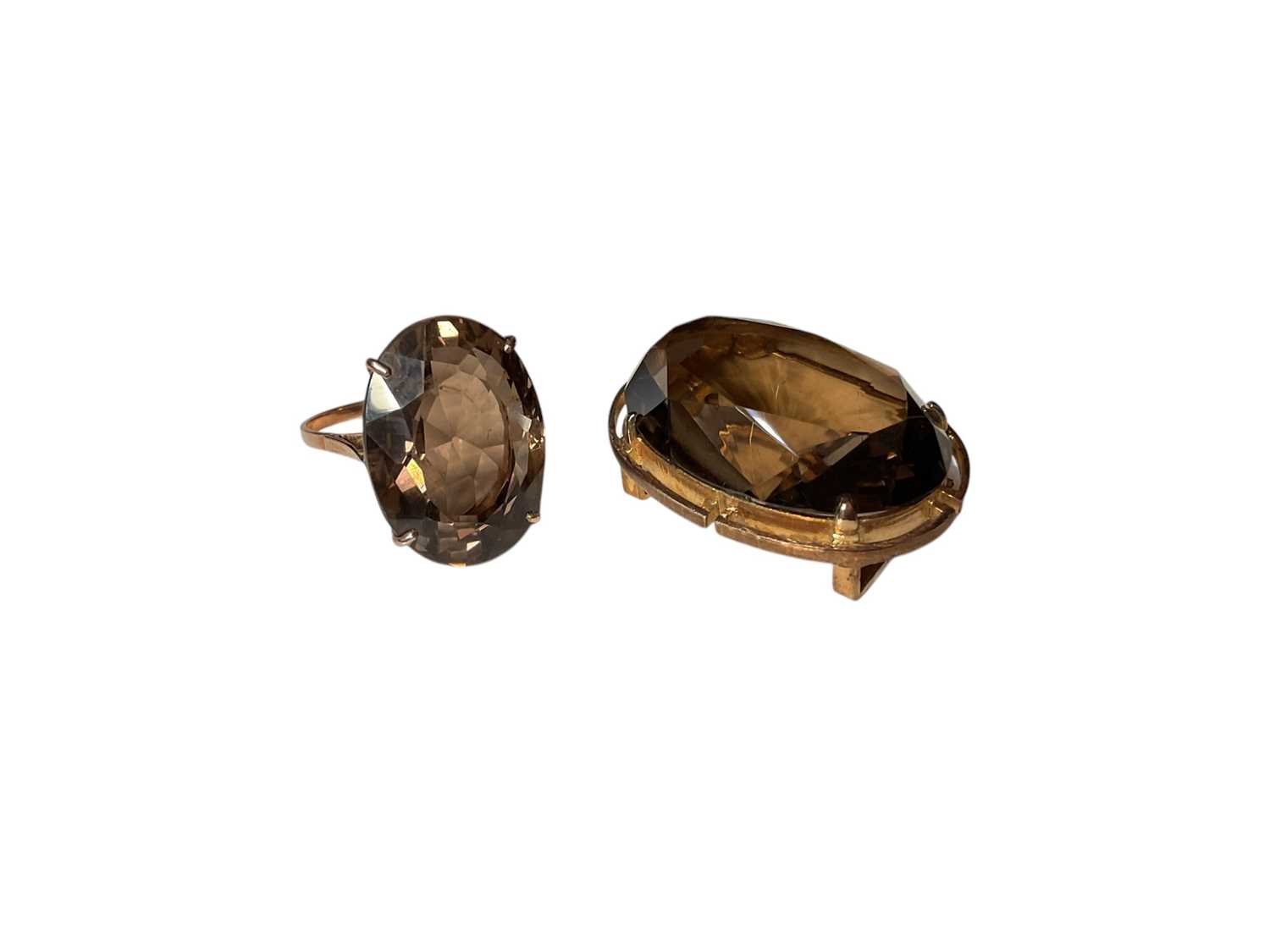 Lot 4 - Large oval mixed cut smoky quartz cocktail ring in yellow metal setting, size R and a similar costume brooch (2)