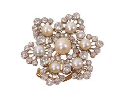 Lot 552 - An Edwardian Belle Époque diamond and pearl star shaped pendant/brooch