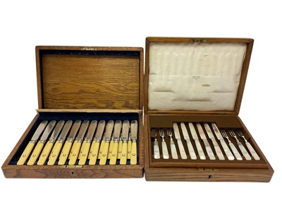 Lot 297 - Two cased sets of monogrammed cutlery