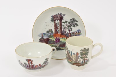 Lot 61 - A Worcester trio, comprising tea cup, coffee cup, and saucer, printed and coloured with classical ruins, gilt rims, the tea cup and saucer with crossed swords marks, the saucer 12.75cm diameter<...
