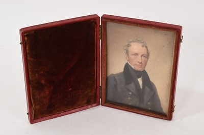 Lot 873 - Early 19th century portrait miniature on paper of a gentleman in folding leather case