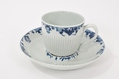Lot 68 - A Worcester fluted trembleuse coffee cup and saucer, circa 1770, painted in blue with lambrequin border, workman's mark, the saucer 13.25cm diameter