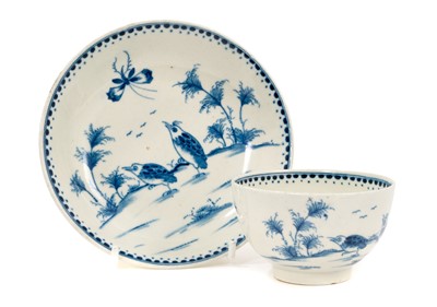 Lot 70 - A rare Worcester tea bowl and saucer, circa 1770, painted in the Japanese style with the Two Quail pattern, dotted borders, crescent marks, the saucer 12.75cm diameter