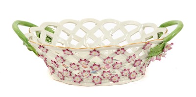 Lot 50 - A Worcester basket, circa 1770, painted in the London atelier of James Giles with fruit and insects, the handles issuing flowers and leaves, the pierced sides applied with florets, picked out in...