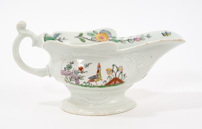 Lot 9 - An early Worcester moulded sauceboat, circa 1753-54, finely painted in polychrome enamels with birds amongst trees and rockwork in the Chinese style, within moulded cartouches on each side, flow...