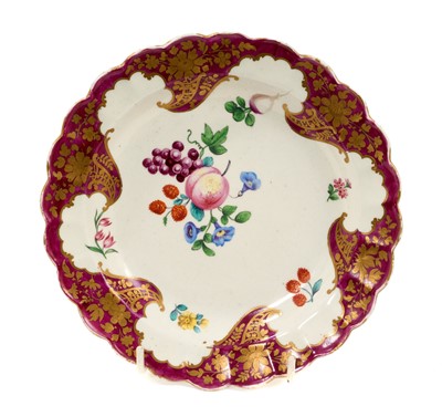 Lot 48 - A Worcester dessert plate of Hope-Edwardes type, circa 1770, painted in the atelier of James Giles with fruit, vegetable and floral sprays within a scroll claret border with cisele gilding, 17.5...