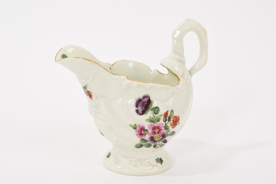 Lot 24 - A Worcester Dolphin Ewer cream boat, circa 1770, with crisp moulding, polychrome painted with floral sprays, gilt rim, 8.25cm high