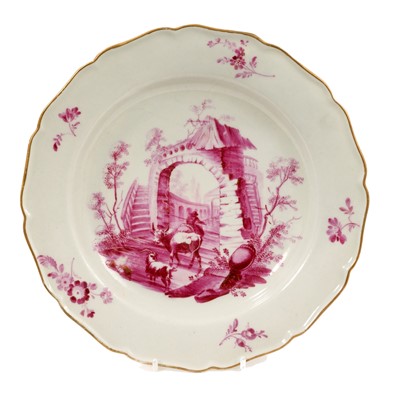 Lot 52 - A rare Worcester plate of 'Grubbe' type, circa 1770, painted in puce in the atelier of James Giles with figures in classical ruins, in the style of Tournai porcelain, with sprays to the edge, gi...