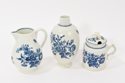 Lot 77 - Worcester tea canister, sparrow beak jug, and mustard pot and cover, circa 1770-80, all printed in blue with the Three Flowers pattern, crescent marks, the canister 14cm high (4)