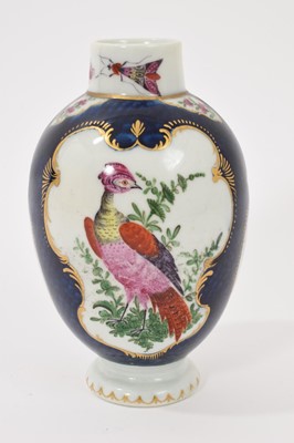 Lot 39 - A Worcester tea canister, circa 1770, polychrome painted with exotic birds, insects and flowers within gilt scroll cartouches, on a scale blue ground, square mark to base, 12.75cm high