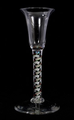 Lot 84 - A red and green colour twist wine glass, circa 1765, the bell bowl on a stem containing a multi-ply corkscrew and alternating red, green and white spiral threads, over a conical foot, 15.9cm hig...