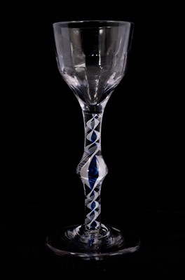 Lot 86 - A blue colour twist wine glass, circa 1770, the ogee bowl with moulded fluting, on a knopped stem containing a pair of opaque white tapes filled in between with dark translucent blue, emcircled...