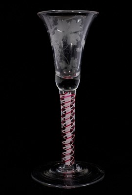 Lot 87 - A continental red colour twist wine glass, circa 1780, the bell bowl etched with a bird and grapevines, on a double series opaque twist stem containing red and white bands outside a fine gauze c...