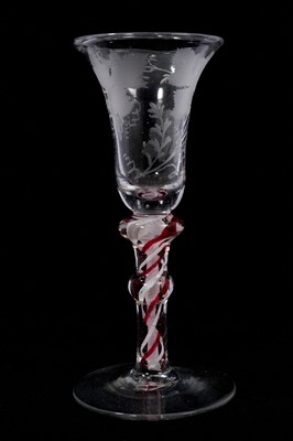 Lot 88 - A continental red colour twist wine glass, circa 1780, the bell bowl etched with grapevines, on a double-knopped stem containing a pair of red and white bands outside a double series opaque twis...