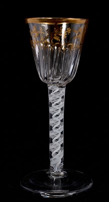 Lot 89 - A wine glass, circa 1765, the round funnel bowl with spiral fluting, decorated in gilt with sprays of roses in the atelier of James Giles, on a double series opaque twist stem, on a conical foot...
