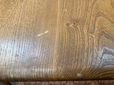Lot 1252 - Ercol extending dining table with two extra leaves opening to 226cm x 90cm (155cm with no leaves) together with a set of eight Ercol stick back chairs including one carver