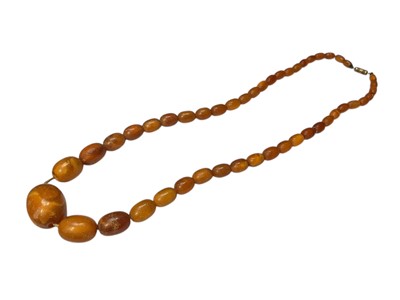 Lot 83 - Vintage amber bead necklace with a string of oval polished graduated beads