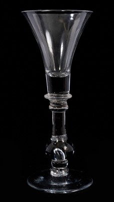 Lot 94 - A heavy baluster wine glass, circa 1720, the trumpet bowl on a heavy baluster stem with collar and annular knop, over a true baluster with tear, on a conical foot, 18.3cm high