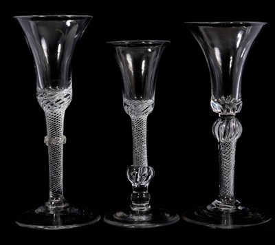 Lot 99 - Three air twist bell bowl wine glasses, circa 1740-50, the first on a multi spiral air twist stem with vermicular collar, the second with teared bowl on a shoulder-knopped MSAT stem, and the thi...