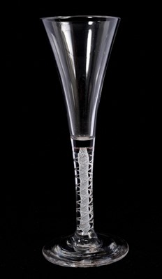 Lot 104 - A rare mixed twist stem wine glass, circa 1770, with a drawn trumpet bowl over a stem consisting of a central spiral of white enamel gauze surrounded by a pair of mercury air twists, on a conica...