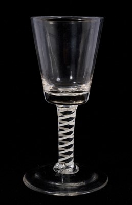 Lot 108 - An opaque twist wine glass, circa 1765, with a bucket bowl above an opaque twist stem consisting of a pair of thick spiral tapes, above a conical foot, 15.25cm high