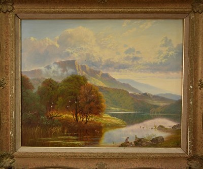 Lot 1427 - Andrew Grant Kurtis, oil on canvas - A mountainous lakeland scene with anglers and their dog, signed, 40cm x 50cm, in gilt frame