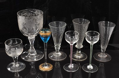 Lot 115 - Group of mostly antique glasses, including three wrythen moulded wine glasses, a 19th century goblet engraved with grapevines, colour twist liqueur glasses, etc