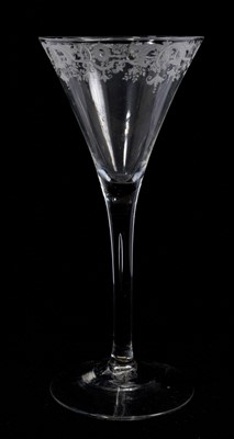 Lot 114 - A plain stem wine glass, circa 1750, the drawn trumpet bowl with band of fine baroque engraving, above a plain stem with slim tear, on a conical foot, 18.9cm high