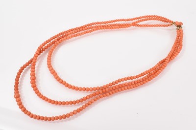 Lot 698 - Antique coral bead 3 strand necklace on gold clasp