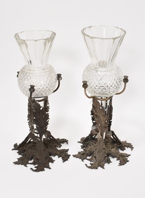 Lot 117 - A pair of 19th century cut glass spill vases of thistle form, on silver plated stands decorated with thistles and foliage, together with a pair of Regency cut glass salts on stands