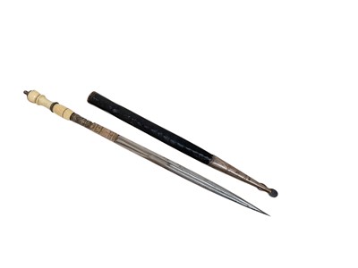 Lot 855 - Late 19th century stiletto dagger with long tapered blade and ivory grip, in leather sheath with white metal chape, 32cm in overall length.