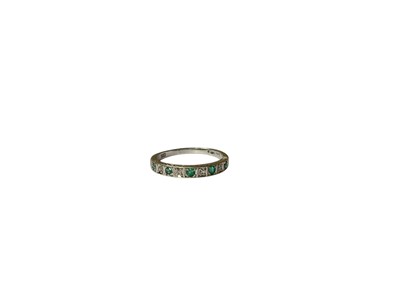 Lot 58 - Emerald and diamond half eternity ring in 9ct white gold setting