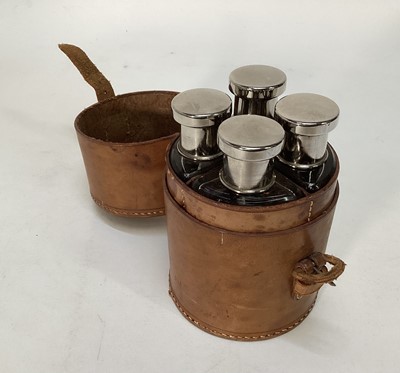 Lot 1134 - Early 20th century good quality set of four hunting flasks/spirit bottles in leather case, 15cm high