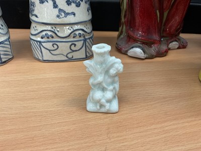 Lot 5092 - White glazed porcelain small taperstick, in the form of a boy with a cornucopia