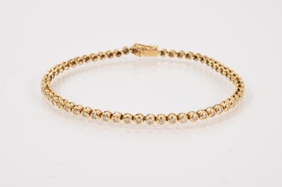 Lot 681 - Diamond tennis bracelet with brilliant cut diamonds in 18ct gold rub over setting