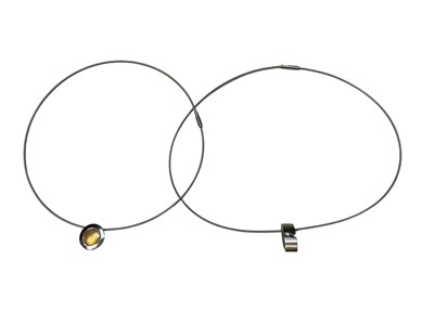 Lot 12 - Michael Birnie - contemporary diamond and stainless steel pendant on stainless steel wire cord necklace together with a similar Modernist gold and stainless steel pendant necklace (2)