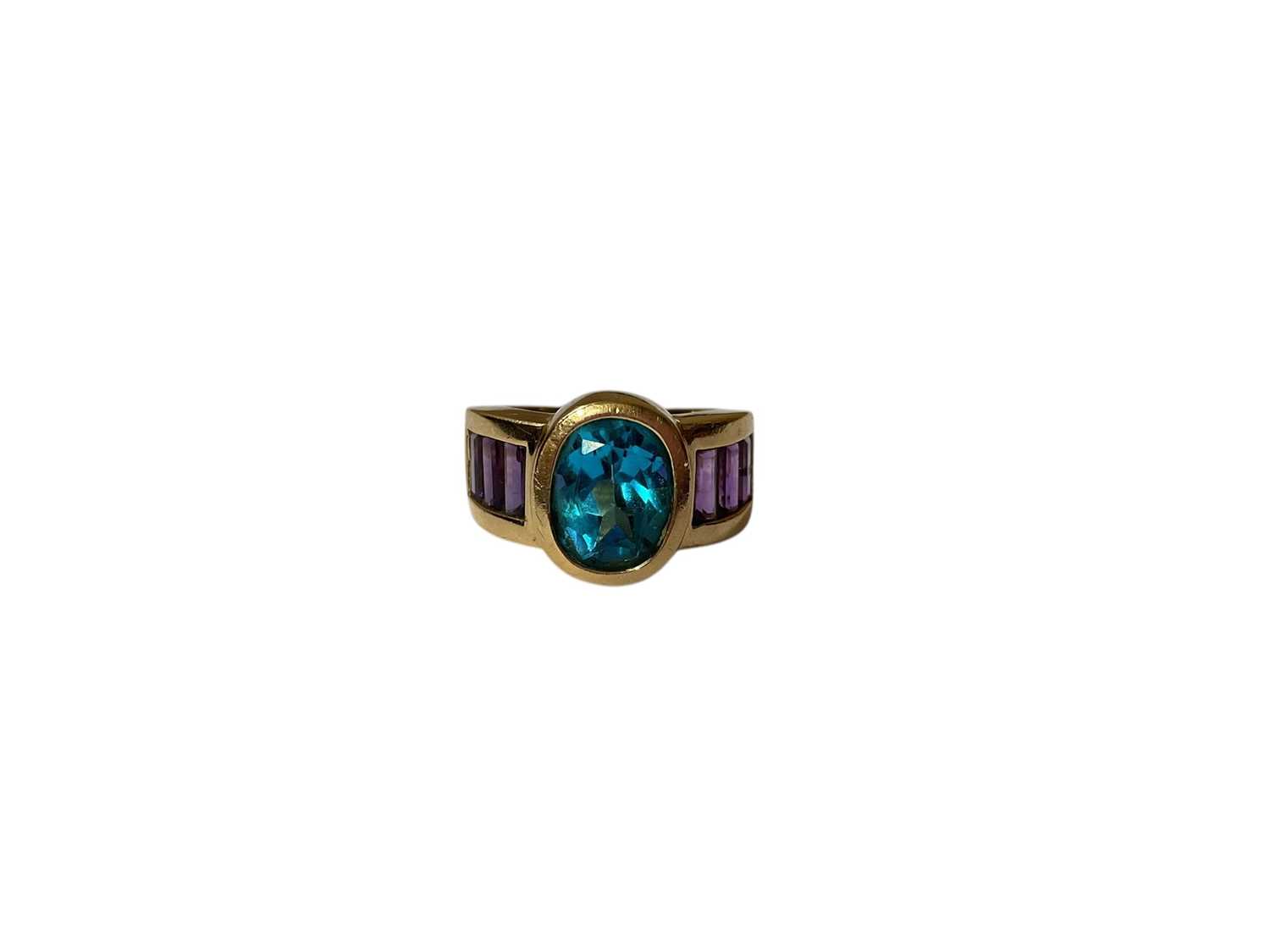 Lot 27 - Blue topaz and amethyst dress ring in yellow gold setting (stamped 14K)