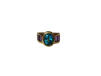 Lot 27 - Blue topaz and amethyst dress ring in yellow gold setting (stamped 14K)