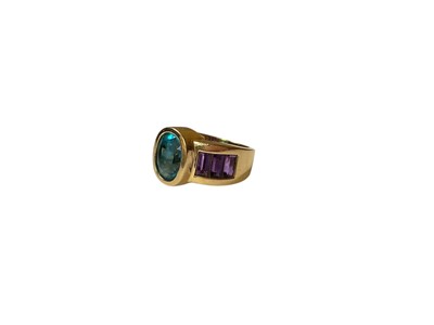 Lot 27 - Blue topaz and amethyst dress ring in yellow gold setting (stamped 14K)