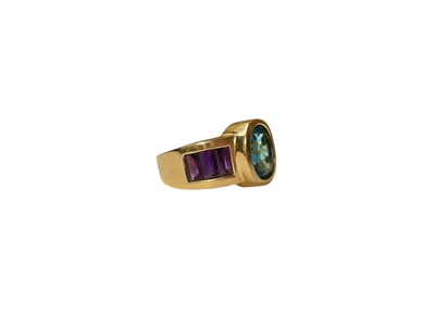 Lot 27 - Blue topaz and amethyst dress ring in yellow gold setting (stamped 14K)