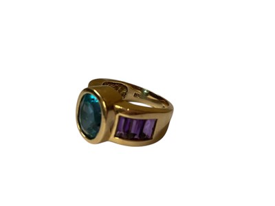 Lot 27 - Blue topaz and amethyst dress ring in yellow gold setting (stamped 14K)